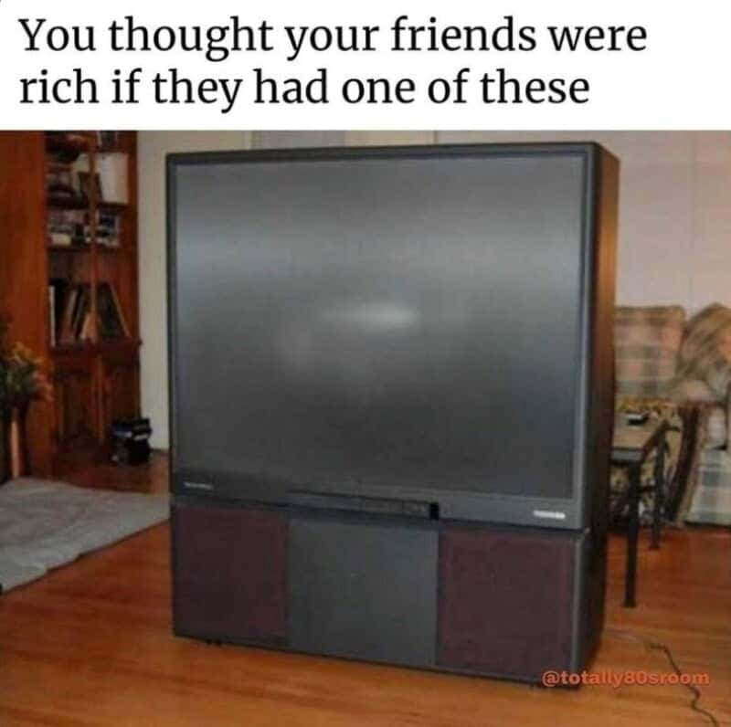 nostalgia meme about neighborhood status symbols showing a giant, boxy rear-projection big-screen TV sitting in an old-school living room under the text "You thought your friends were rich if they had one of these".