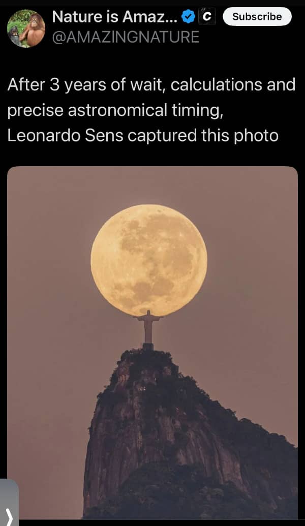 Perfectly aligned perspective photograph of the full moon resting on the Christ the Redeemer statue hands.