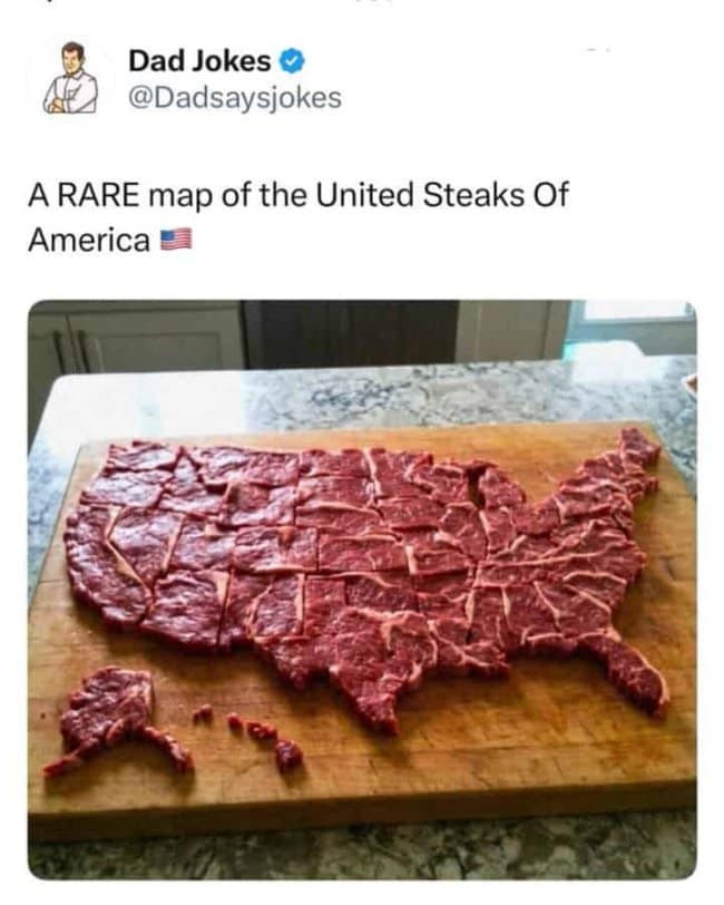 A culinary-themed funny pun screenshot features a popular tweet from the verified Dad Jokes (@Dadsaysjokes) account stating, "A RARE map of the United Steaks Of America." The photograph underneath shows a large wooden cutting board topped with raw, marbled beef meticulously cut and arranged into the precise geographical layout of the United States.