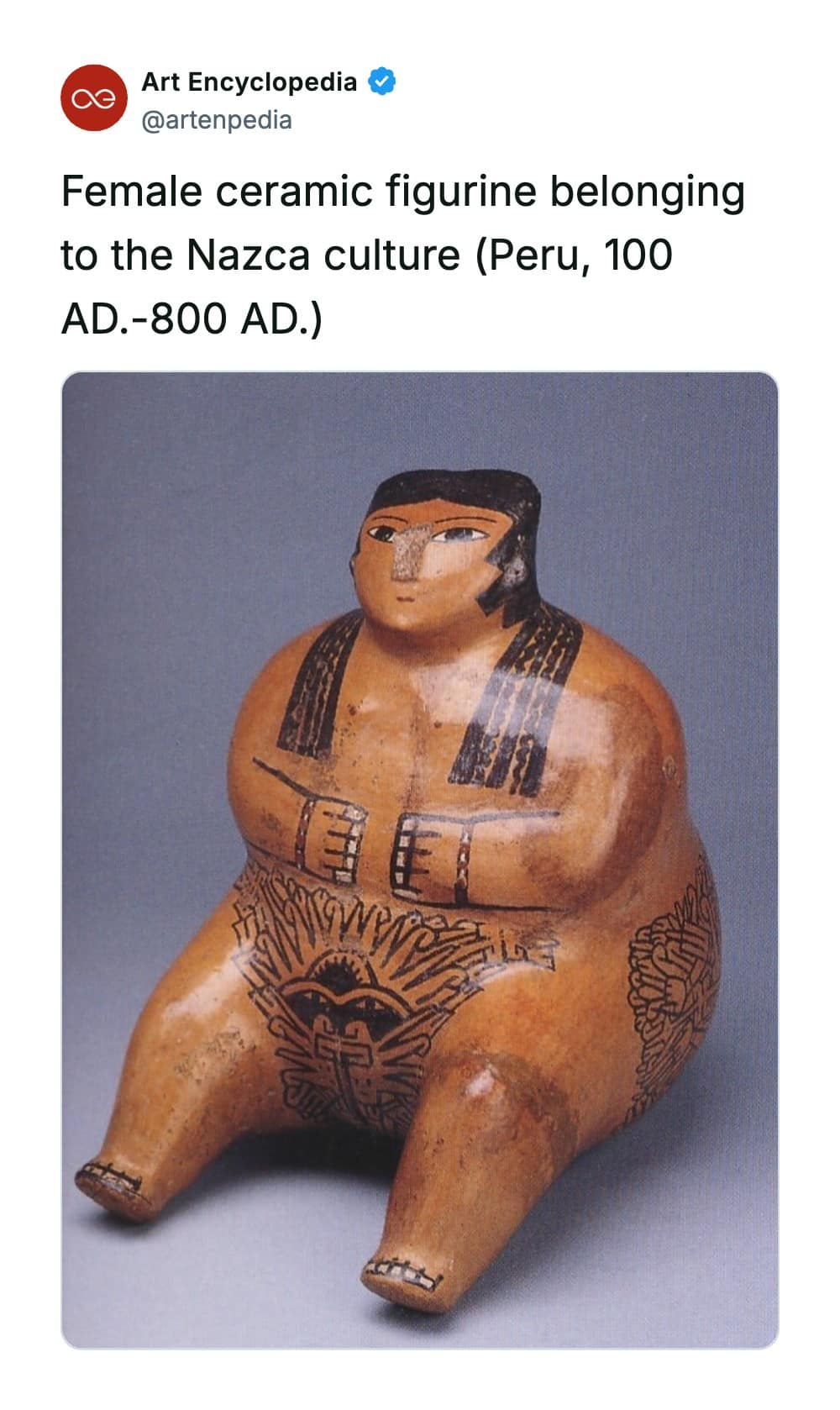 A rare historical photo of a seated female ceramic figurine from the ancient Nazca culture of Peru (100–800 AD), showcasing a polished earthenware form detailed with sharp geometric facial painting and complex fine-line iconography across her lower body.