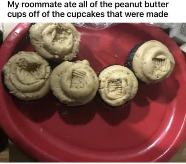 Five chocolate cupcakes on a red plate with all the peanut butter cups missing from the tops.