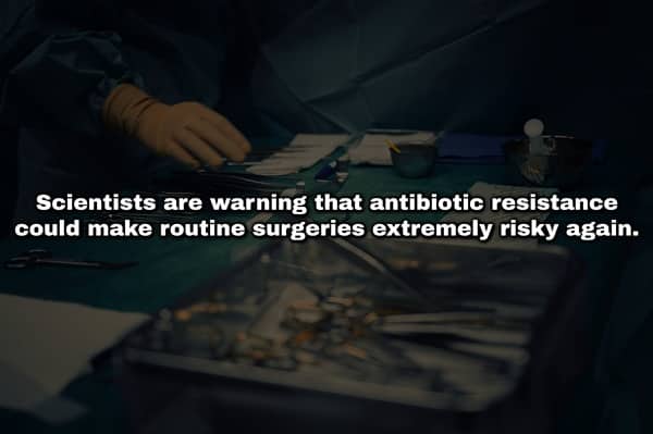 Blurred view of surgical instruments on a green tray with text warning of antibiotic resistance.