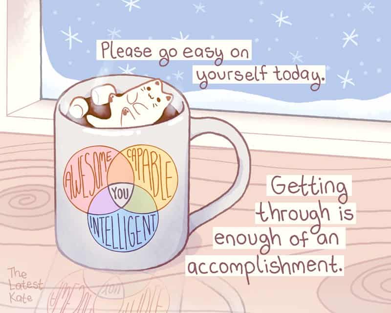 A cozy winter single panel comic from the latest kate comics showing a white mug filled with hot chocolate on a wooden desk, where a marshmallow shaped like a sleeping cat floats lazily next to a Venn diagram reading "Awesome," "Capable," and "Intelligent" overlapping at "You," labeled with the quote: "Please go easy on yourself today. Getting through is enough of an accomplishment."