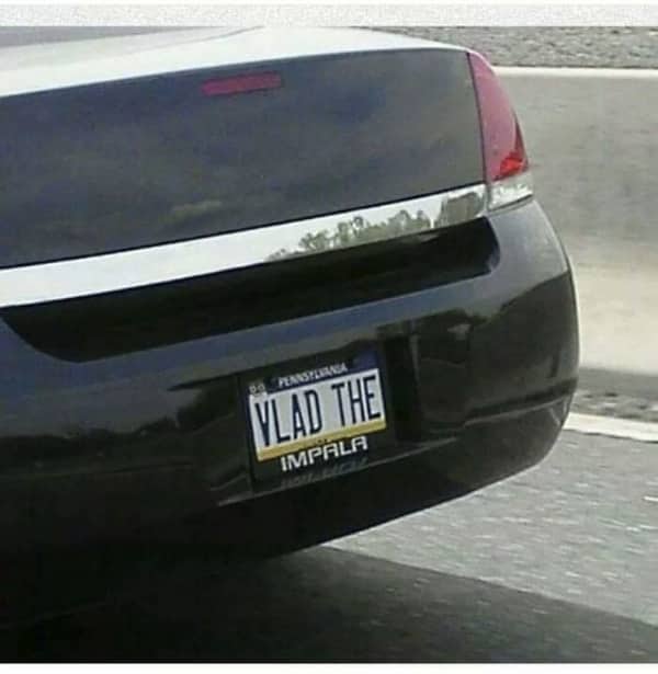 Close-up of a black Chevrolet car trunk featuring a custom Pennsylvania license plate that reads Vlad The Impala.