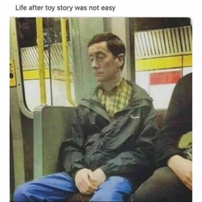 A candid photo of a man on a subway train who bears a striking resemblance to Woody.