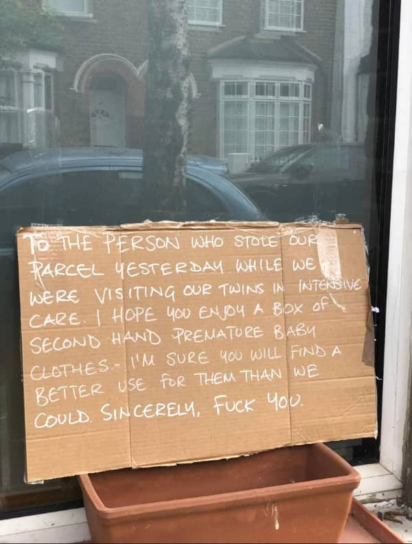 Cardboard box note cursing out a porch pirate who stole a package containing secondhand premature baby clothes.