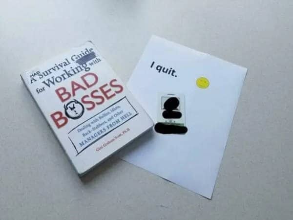 A short, simple resignation note paired with a survival guide book for bad bosses.