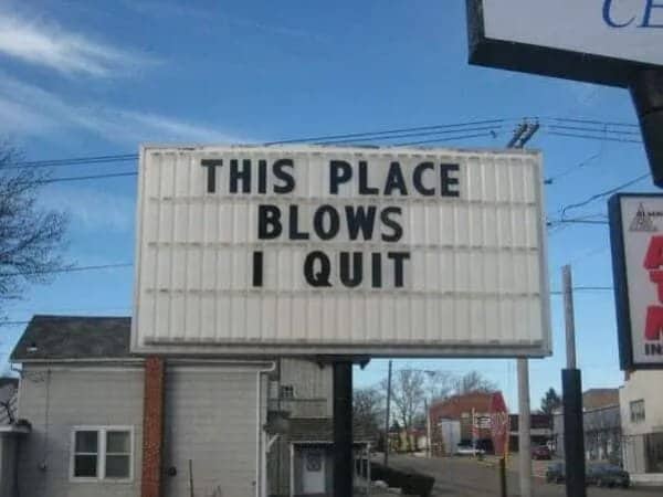 Large outdoor changeable letter marquee sign reading this place blows I quit.