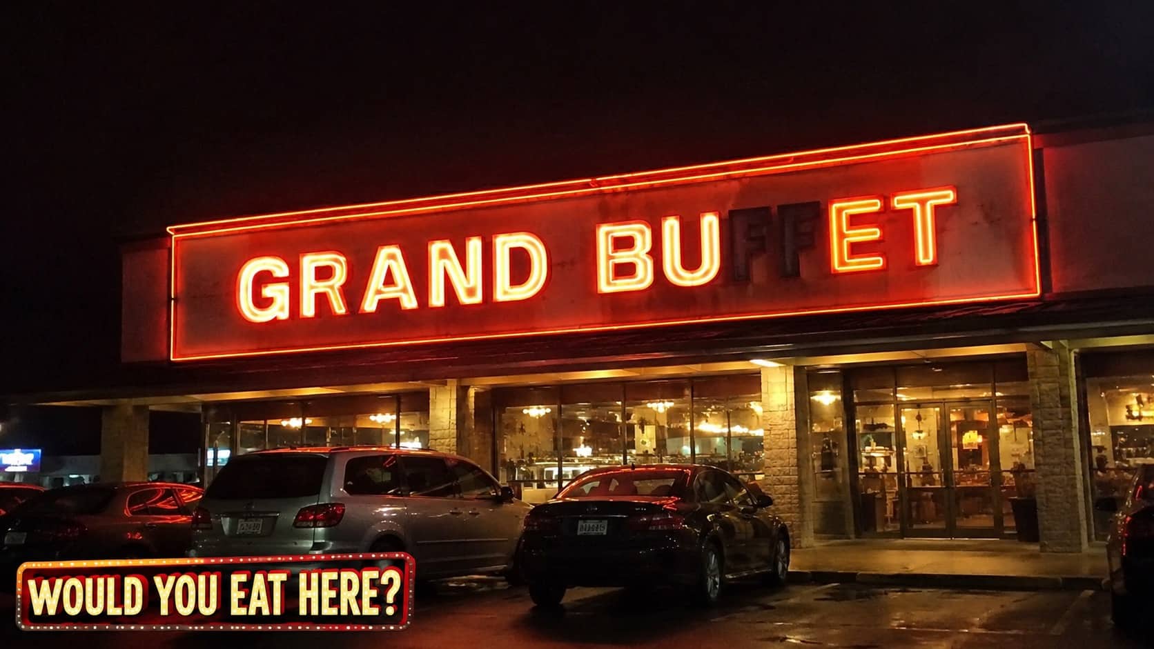 Funny broken neon sign reading grand buffet at night with parking lot cars in front.