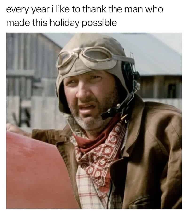 A cult-classic cinematic 4th of july meme pays annual tribute to a fictional sci-fi hero with a close-up film still of actor Randy Quaid playing pilot Russell Casse in the 1996 blockbuster Independence Day. The text overhead dryly states, "every year i like to thank the man who made this holiday possible," celebrating his legendary sacrifice against an alien invasion.