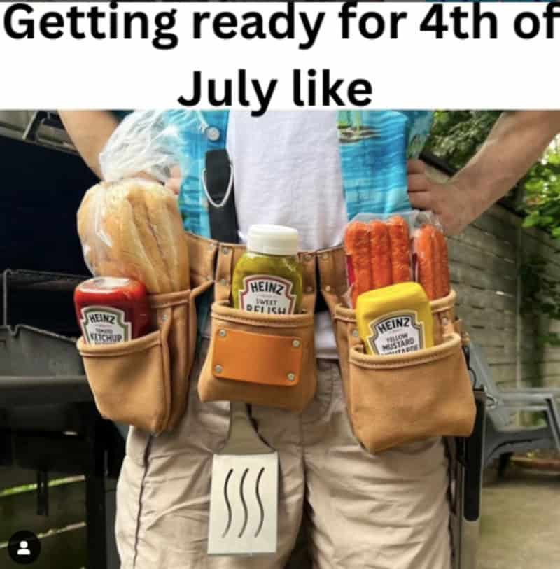 A hyper-prepared 4th of july meme features a close-up photo of a suburban griller geared up for a backyard patio session under the header, "Getting ready for 4th of July like." The cook is seen wearing a heavy-duty leather construction tool belt where every single pocket has been custom loaded with a bottle of Heinz ketchup, sweet relish, a package of raw hot dogs, yellow mustard, and a metal spatula hanging down.