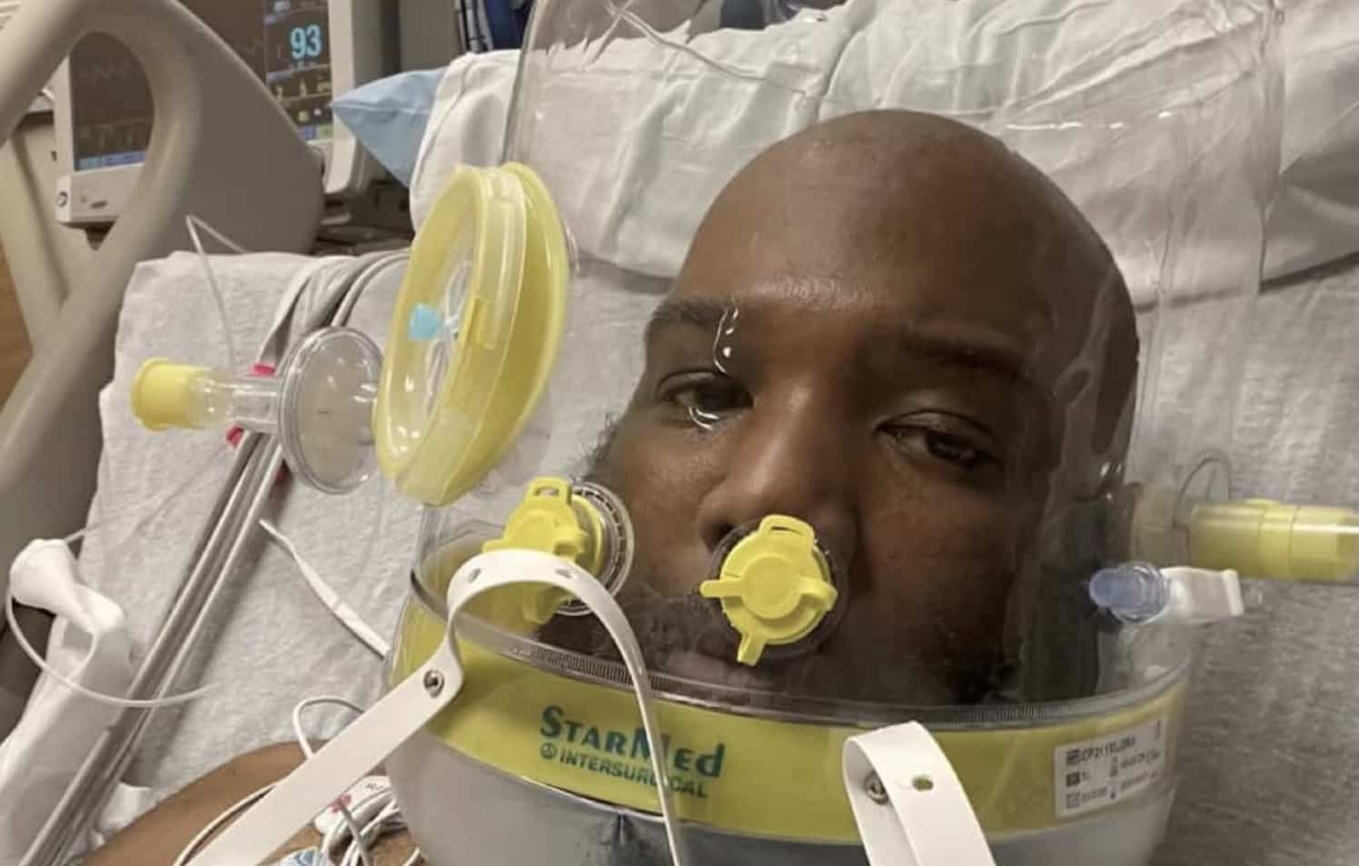 Patient wearing clear medical helmet in hospital bed funny memes reaction image close up.