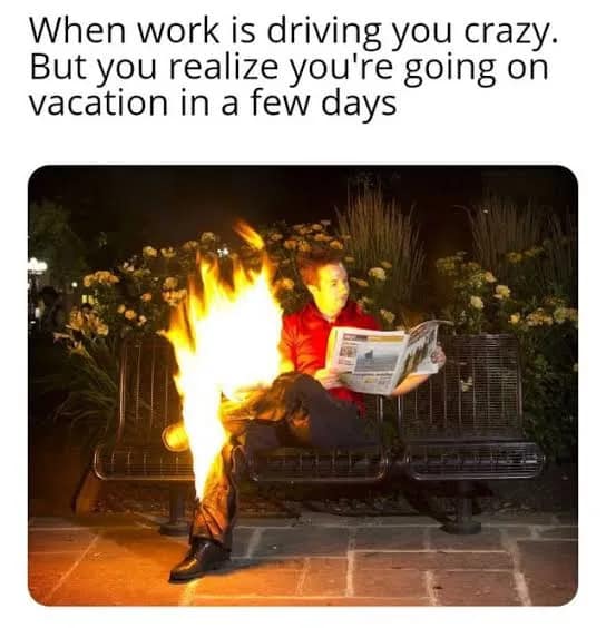 This chaotic classic meme illustrates office burnout with a man calmly reading a newspaper on a bench while his lower leg is completely engulfed in flames.