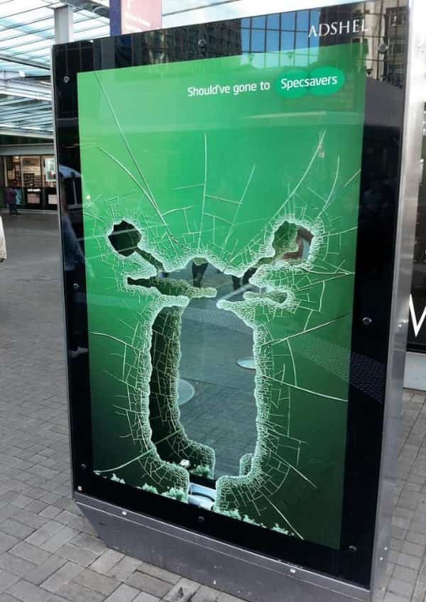 Specsavers bus stop poster featuring shattered glass cut out like a crashed scooter creative ad.