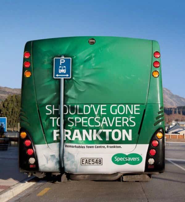 Specsavers creative ad on a bus rear artificially crumpled into a bus stop pole.