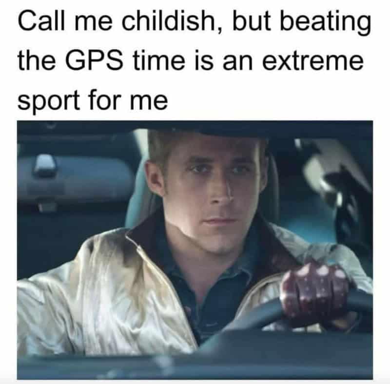 A relatable driving meme featuring Ryan Gosling's intense, hyper-focused face behind the wheel in Drive, representing the high-stakes extreme sport of trying to beat the GPS arrival time.