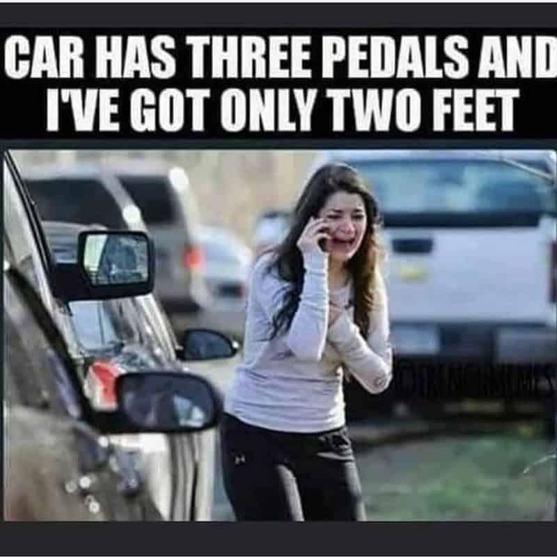 An entertaining driving meme displaying a panicked woman on her cell phone by the road, paired with a text block struggling to understand how manual transmission cars have three pedals when humans only possess two feet.
