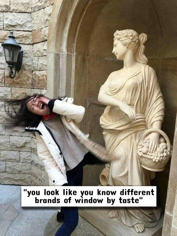 Woman dramatically reacting to a stone statue as if hit by a surreal, highly-specific insult.