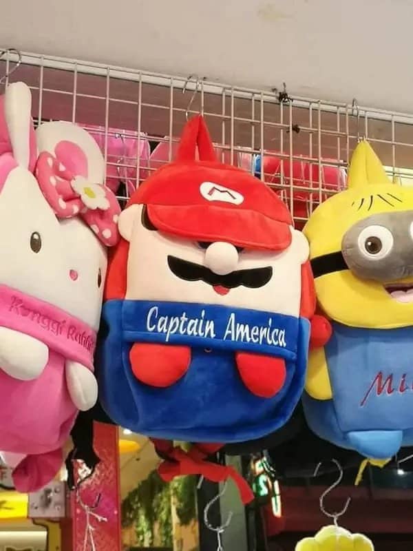 Plush Mario backpack mislabeled with the Captain America name among funny fake products.