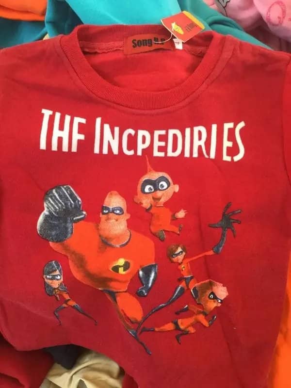 Red children shirt displaying Disney Incredibles characters with funny fake products text THF INCPEDIRIES.