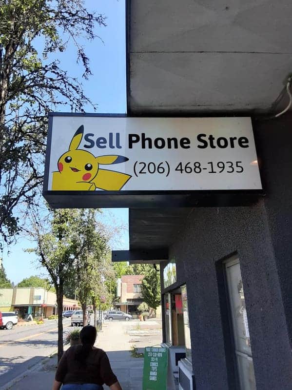 Exterior store sign reading Sell Phone Store featuring a picture of the Pokémon character Pikachu.