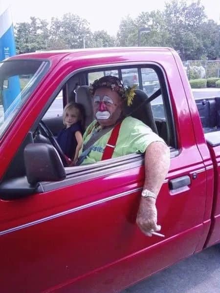 Funny memes featuring a grumpy clown smoking a cigarette in a red pickup truck.