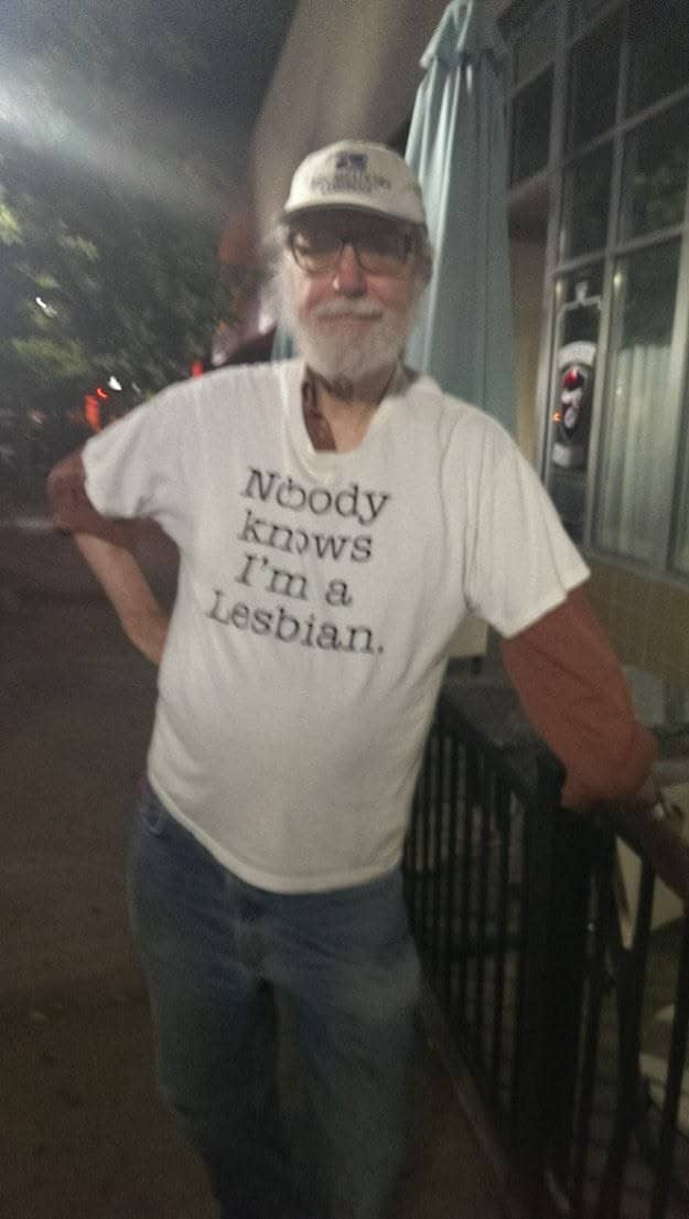 Elderly bearded man wearing an ironic lesbian slogan shirt highlighting bizarre style in funny outfits.