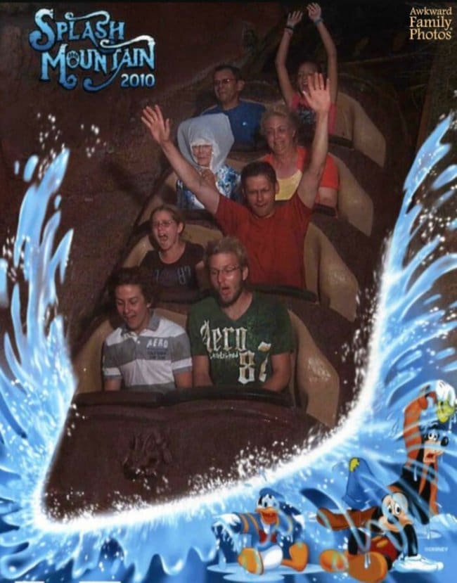 An elderly woman calmly wearing a plastic rain bonnet surrounded by screaming riders on Splash Mountain