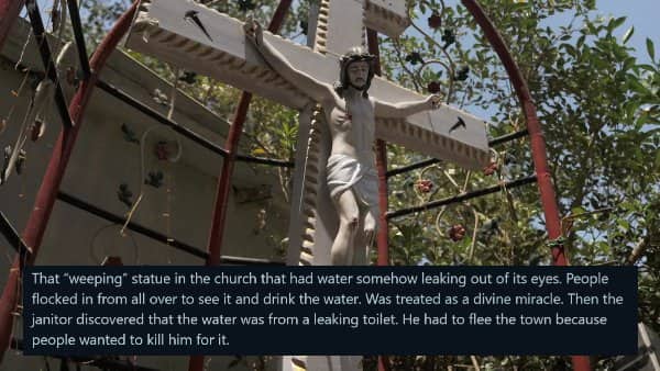 A statue of Jesus on a crucifix outdoors, detailing a weeping miracle solved by a leaking toilet.