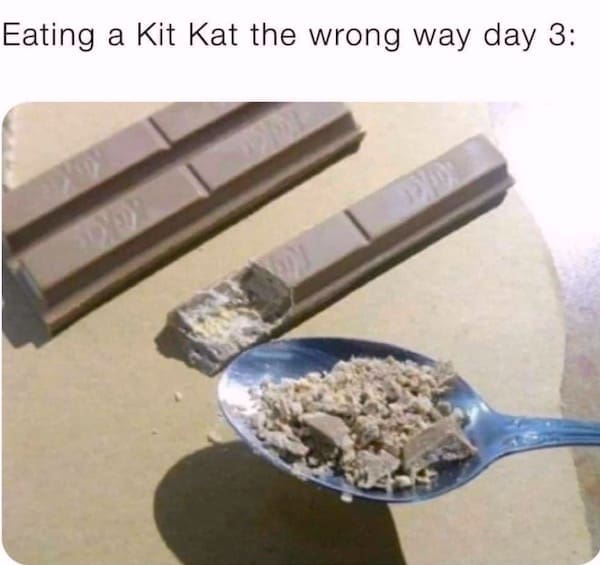 An absolute culinary-crime funny meme documents a disturbing snack experiment labeled, "Eating a Kit Kat the wrong way day 3:". The photograph shows a classic chocolate Kit Kat bar that has been completely pulverized into a fine, powdery gravel and piled onto a silver metal spoon, with the mangled remains of the candy bar resting on cardboard behind it.