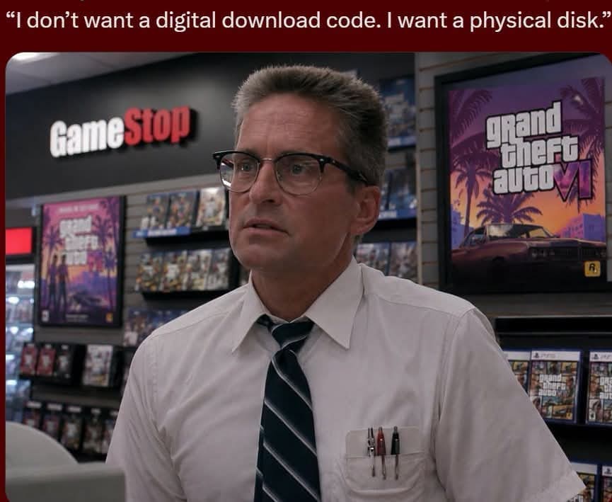 An iconic movie-mashup funny meme splices Michael Douglas from the movie Falling Down directly into a modern retail shop under the quote, "“I don’t want a digital download code. I want a physical disk.”" The angry, white-shirted character is seen confronting a counter clerk inside a GameStop store adorned with promotional posters for Grand Theft Auto VI.