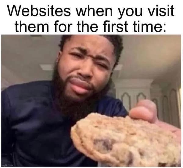 This relatable funny meme highlights intrusive data tracking by showing a man aggressively thrusting a giant chocolate chip cookie directly into the camera lens.