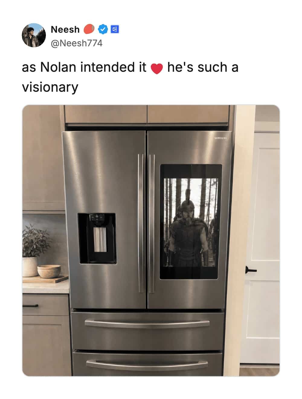 Smart refrigerator door screen displaying movie scenes of ancient Greek warriors standing in a forest.