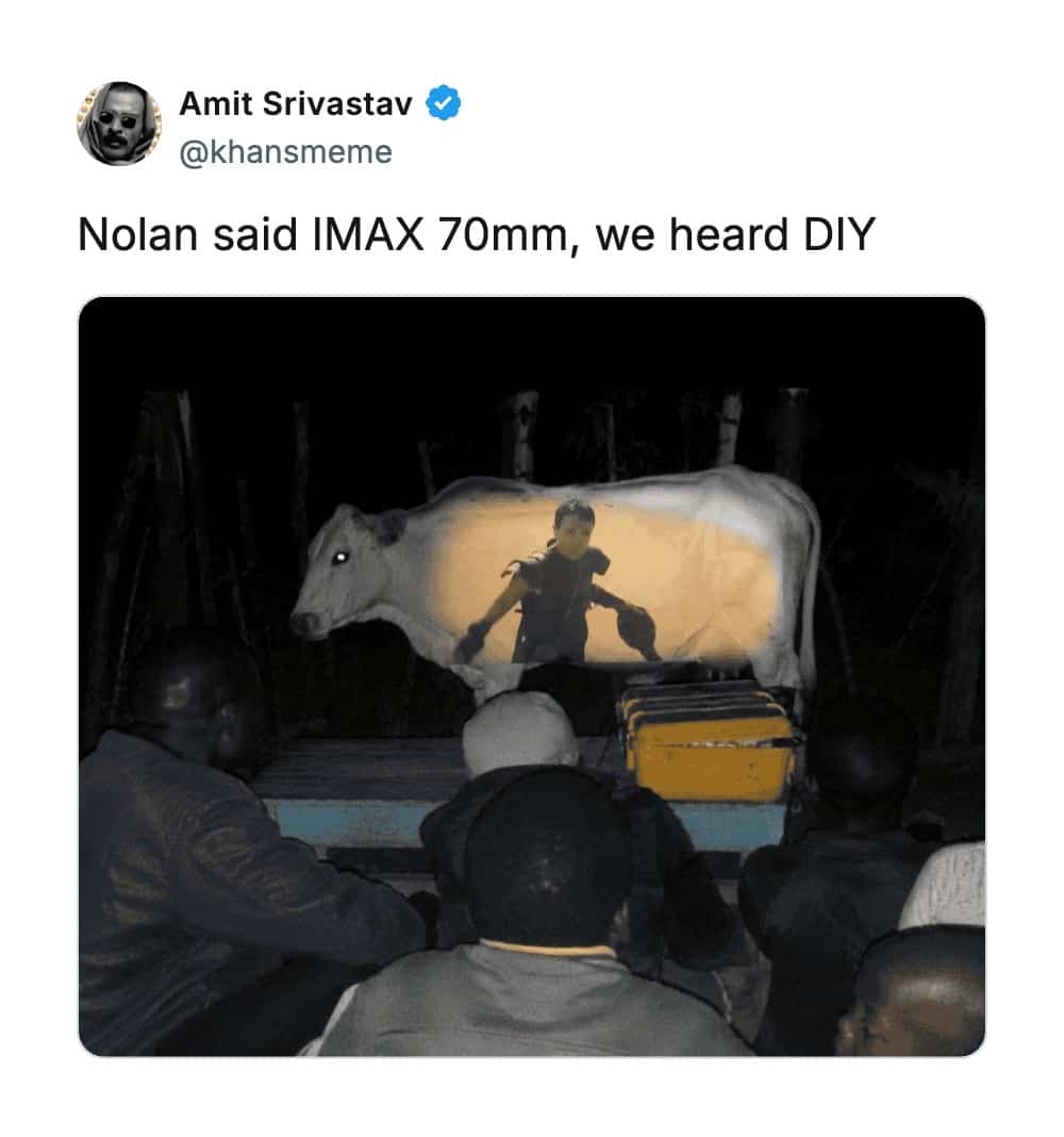 Movie screen projection onto a cow outdoors satirizing high end IMAX film presentation standards.