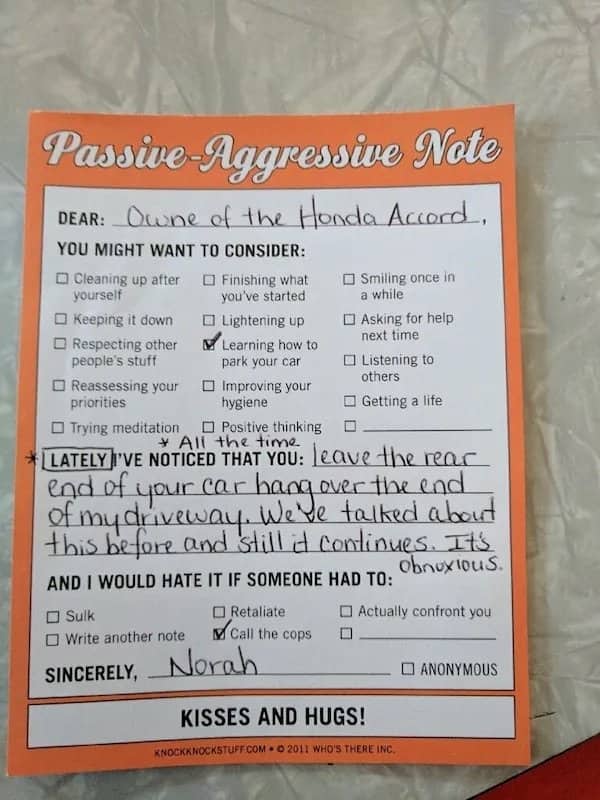 Completed orange passive-aggressive note pad form left for a Honda Accord owner blocking a driveway.