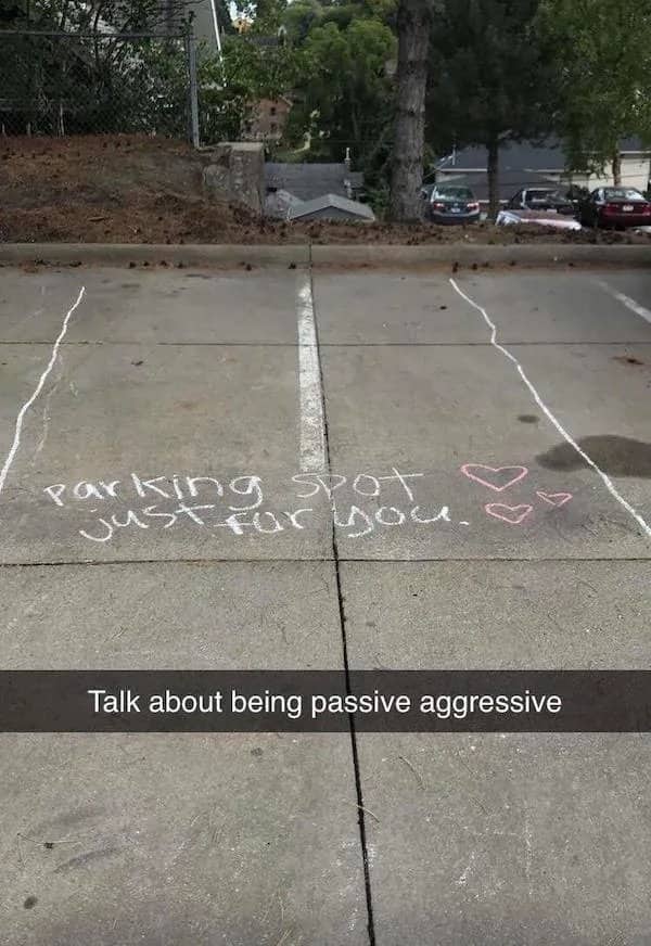Chalk-drawn extended parking spot lines on concrete with the text parking spot just for you.