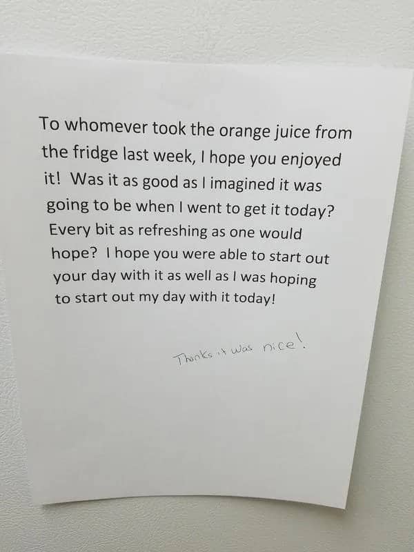 Printed note complaining about stolen orange juice with a handwritten response saying thanks it was nice.