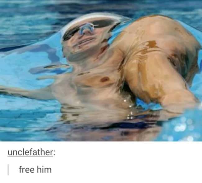 Close up distorted view of swimmer underwater surface refraction distorting head and shoulder shape.