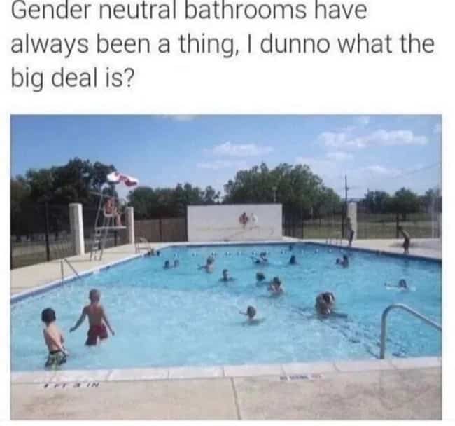Crowded outdoor public swimming pool full of people captioned jokingly as a gender neutral bathroom.