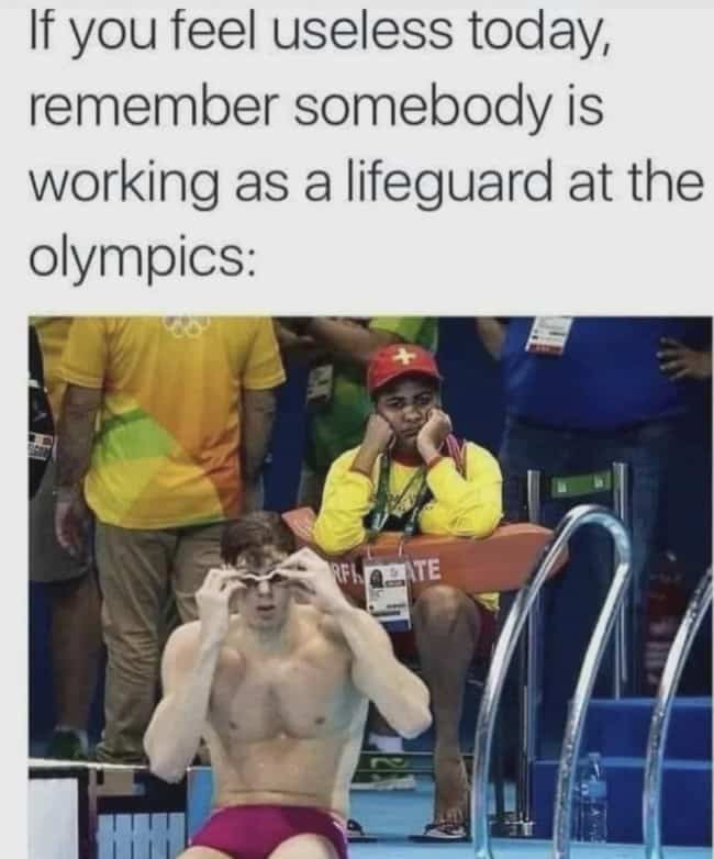 Bored Olympic lifeguard watching world class professional swimmer put on swim goggles at pool.