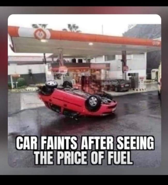 This chaotic road trip meme captures a red car flipped completely upside down on its roof at a gas station with text about the vehicle fainting over fuel prices.