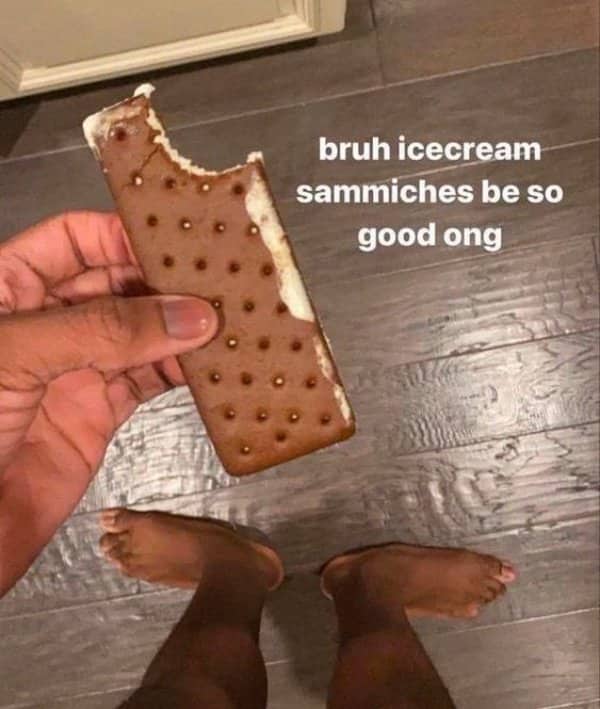 First-person view of an ice cream sandwich with a person's feet facing completely backward