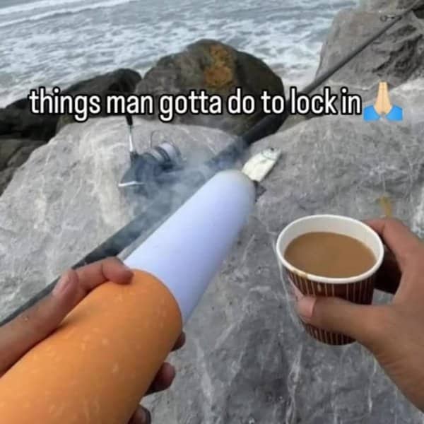 Person holding an absurdly massive novelty cigarette and coffee cup next to a fishing rod.